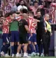 Atletico Madrid's head coach Diego Simeone, right, celebrates with the players after Atletico Madrid's Jonathan David scored their side's second goal during a Spanish La Liga soccer match between Atletico Madrid and Real Madrid in Madrid, Sunday, Sept. 20, 2026. (AP Photo/Bernat Armangue)
